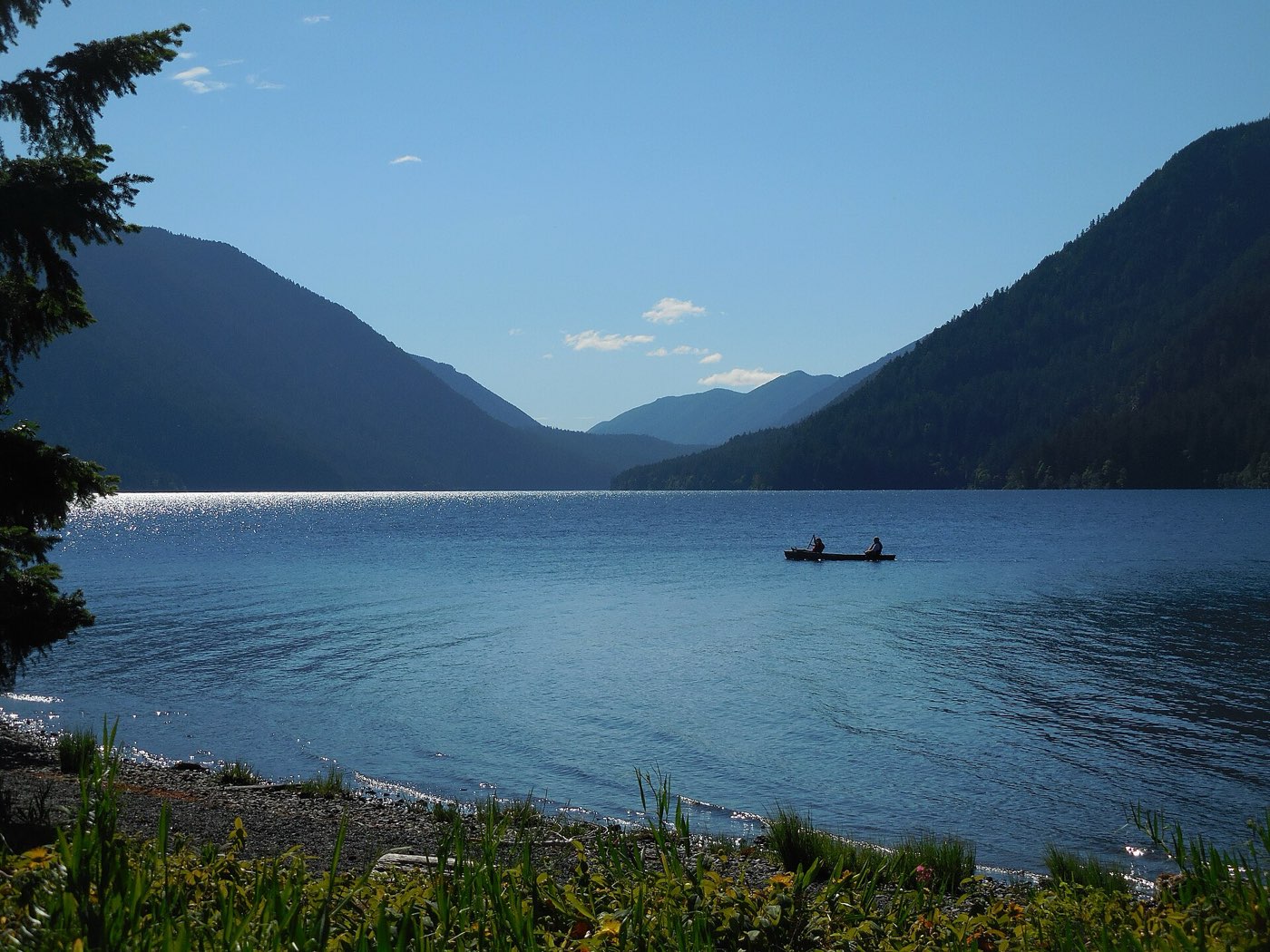 Paddlers crossing a wilderness lake by canoe
