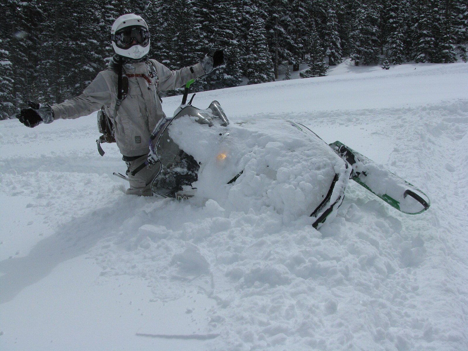 A snowmobiler crossing deep snow